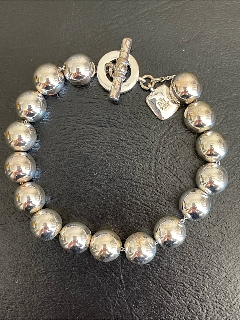 Ralph Lauren silver tone bead bracelet with toggle clasp.